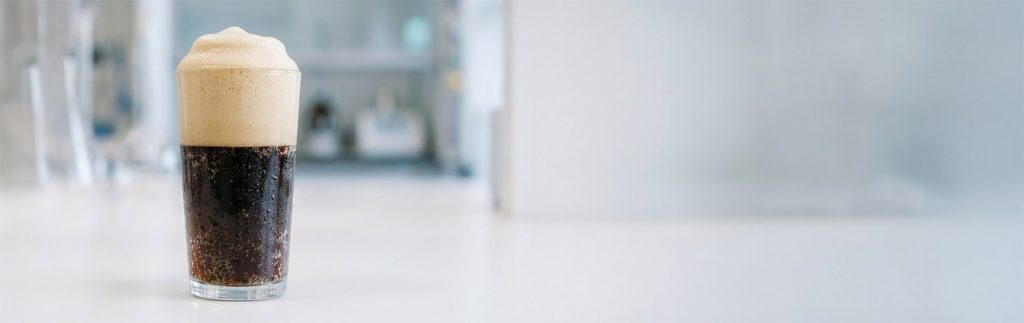 glasses of foaming beverages demonstrating the application of liquid and dry Quillaja extracts in formulation